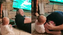 Adorable baby falls over due to uncontrollably laughing at her dad.