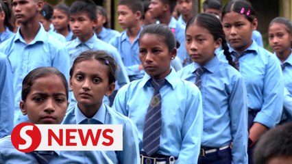 Nepali woman's quest to learn takes her back to school with son