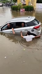 Car floating in flood water