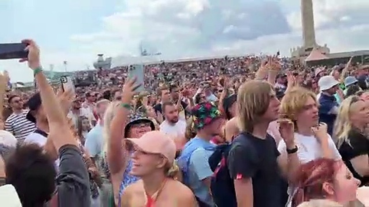 Royal Navy carrier HMS Prince of Wales passes Southsea Common during the Sugababes set at Victorious festival