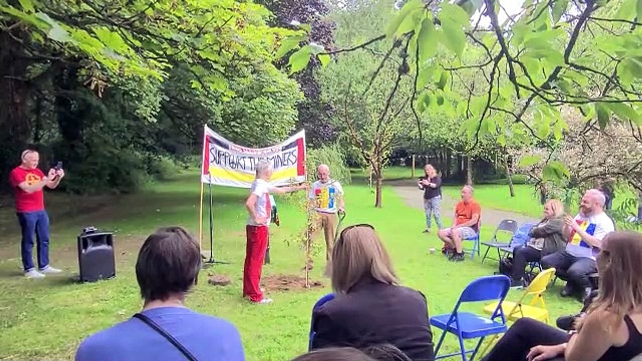 Mike Jackson and Shá Gillespie plant a crab apple tree in memory of Mark Ashton in Derry