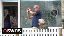 Cricket player smashes ball for six straight through clubhouse window sending spectators diving out of the way