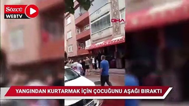 Yangında mahsur kalan anne çocuğunu balkondan aşağı bıraktı