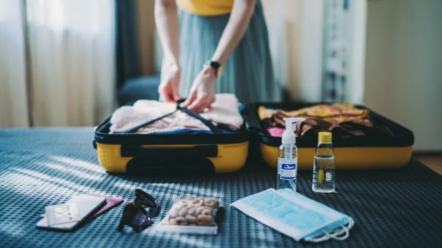 What to Do If You Test Positive for COVID-19 While Traveling, According to Experts