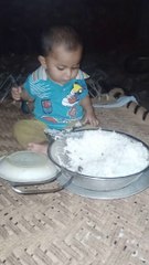 Cut baby eating rise and playing