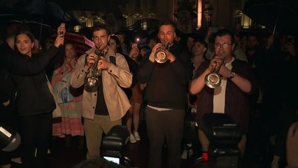 Trumpet players perform national anthem outside palace