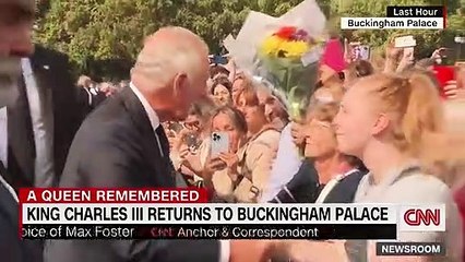 See moment woman kisses King Charles outside palace