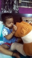 Baby playing with toy dog 