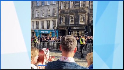 Crowd applauds at the end of God Save the King outside St Giles' Cathedral in Edinburgh