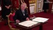 King Charles signals to aide to remove pens during signing of oath