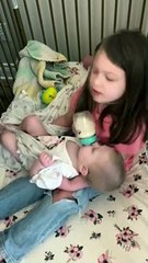 Girl Hums to Baby Sister