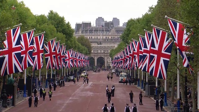 Crowds gather along The Mall ahead of procession