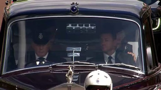 Queen Consort waves to crowds as she arrives at palace