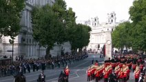 Prince Harry looks down as he passes Cenotaph while King Charles and William salute