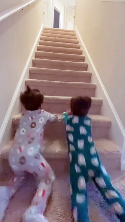 Crazy kids have fun sliding down the stairs