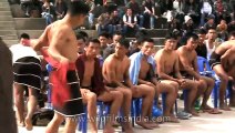 Naga wrester throws an opponent to the ground - Hornbill Naga Wrestling competition
