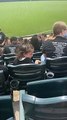 Little girl sticks her hand in random cup of soda at baseball game