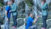 Guy proposes to girlfriend in front of waterfall on her favorite trail