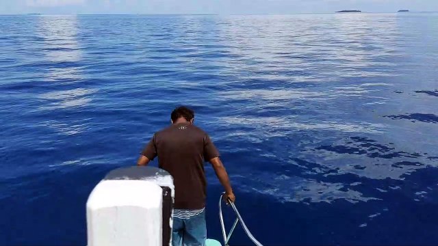 Tourists travel in the deep blue waters of the Maldives.