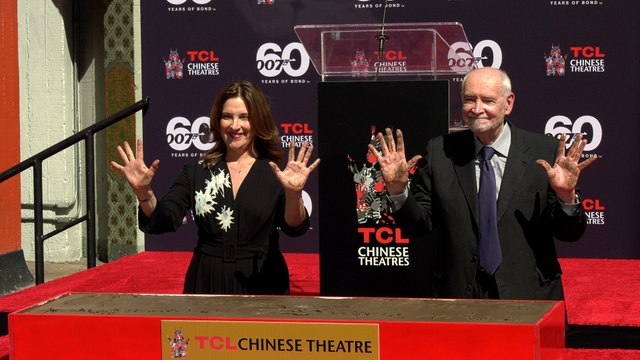 James Bond producers Michael G. Wilson and Barbara Broccoli place their handprints in cement