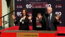 James Bond producers Michael G. Wilson and Barbara Broccoli place their handprints in cement