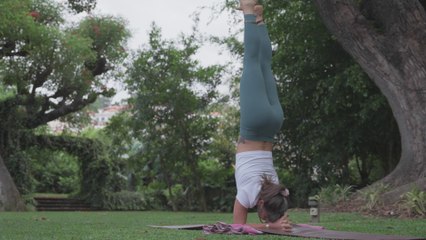 Girl doing the Pincha Mayurasana yoga pose