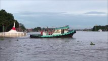 Tugboat pulling a huge barge on the Chao Phraya River Koh Kret Island Thailand
