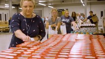 Volunteers pack thousands of bags of groceries in preparation for Hurricane Ian's impacts