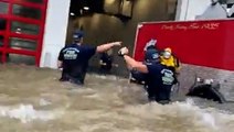 Firefighters wade through deep floodwaters to save truck swamped by Ian
