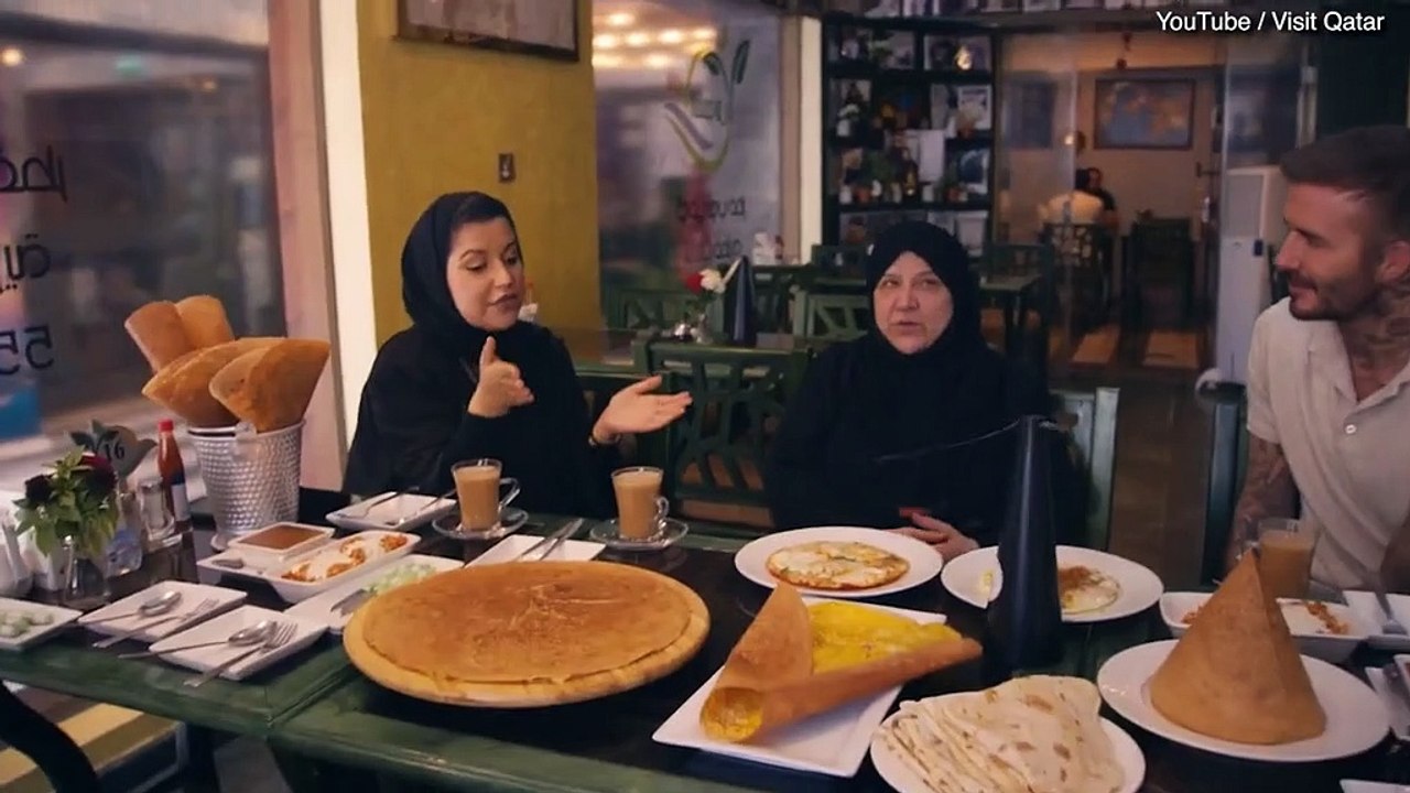 David Beckham sits with Madame Shams Al Qassabi and her daughter.