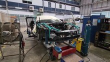 Heavy structural repair of Mercedes-Benz SLC on Celette bench with side and overhead gantries