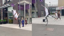 Circus artist entertains public by performing CRAZY acrobatics on bouncy stilts