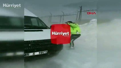 Kar ve tipide öğrenci servisini iten trafik polisinin zor anları kamerada