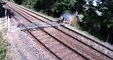 Shocking footage shows young boy playing on live train tracks while his dozy dad chats on a mobile phone