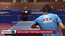 Masa tenisçisi Hamaditu ağzıyla raket tutup masa tenisi oynuyor