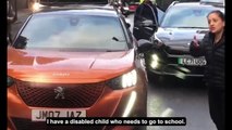 Moment eco-zealots stop disabled child getting to school and block ambulance as furious drivers rage: 'Why are you doing this to people?'