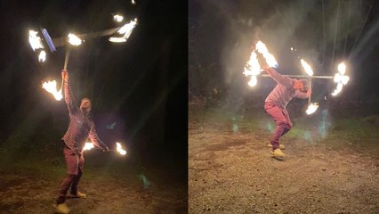 Man throws fear out of the window while performing a CRAZY double fire staff routine