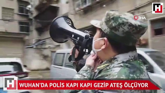 Wuhan’da polis kapı kapı gezip ateş ölçüyor