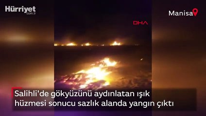 Salihli'de gökyüzünü aydınlatan ışık hüzmesi sonucu sazlık alanda yangın çıktı