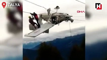 Uçak elektrik tellerinde asılı kaldı, pilot kanada oturup kurtarılmayı bekledi