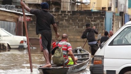 Residents of Nigeria maneuver flood waters