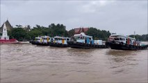 5 tugboats pulling a huge barge at the Chao Phraya River  Koh Kret island Thailand