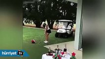 Golf topuyla şampanya patlatan kadın
