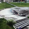 Skateboarder ollies set of stairs and lands on his ankle (Slow motion)