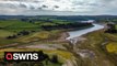 Shocking drone video shows the 'dangerously' low levels at a major reservoir amid warnings further restrictions on water use could be brought in