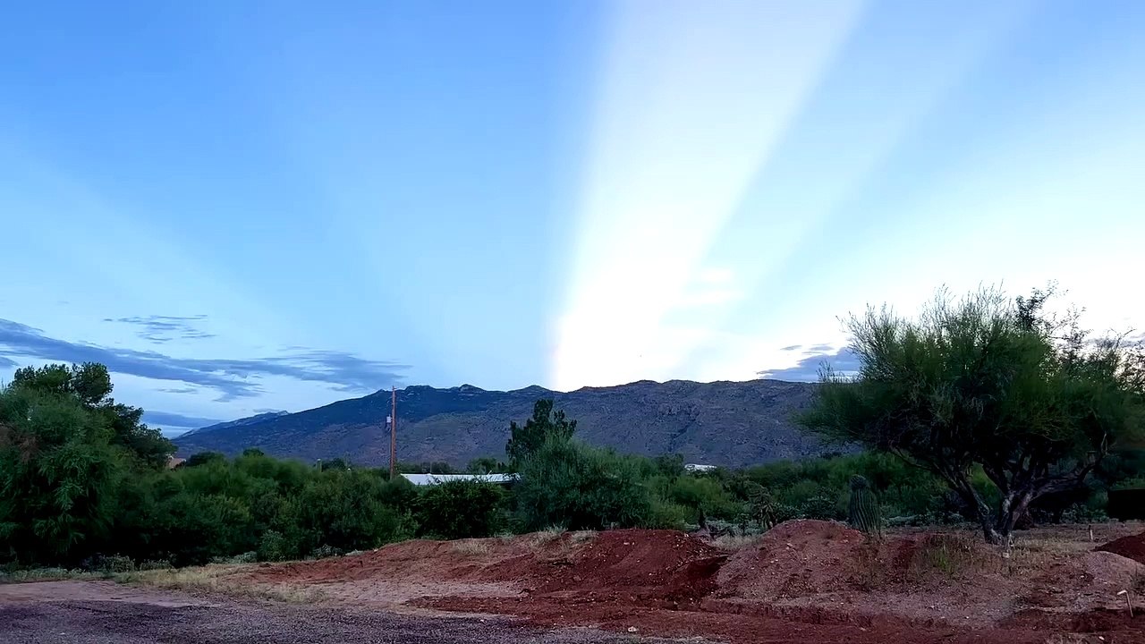 Light Beam From Setting Sun Shoots Across Sky