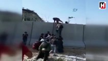Footage shows Syrians scaling Turkish border wall with ladders