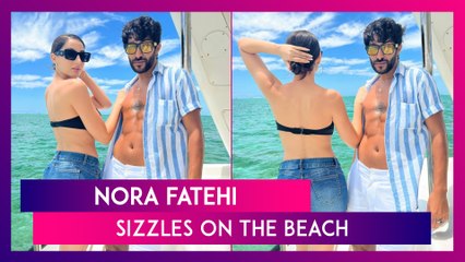 Nora Fatehi Sizzles On The Beach In A Black Strapless Top And Denim Shorts