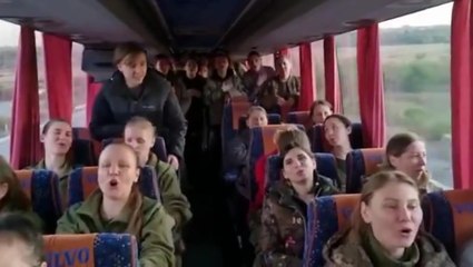 Female Ukrainian soldiers sing on return home after prisoner swap