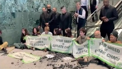 Climate protesters occupy BlackRock HQ, block escalators, throw coal on floor